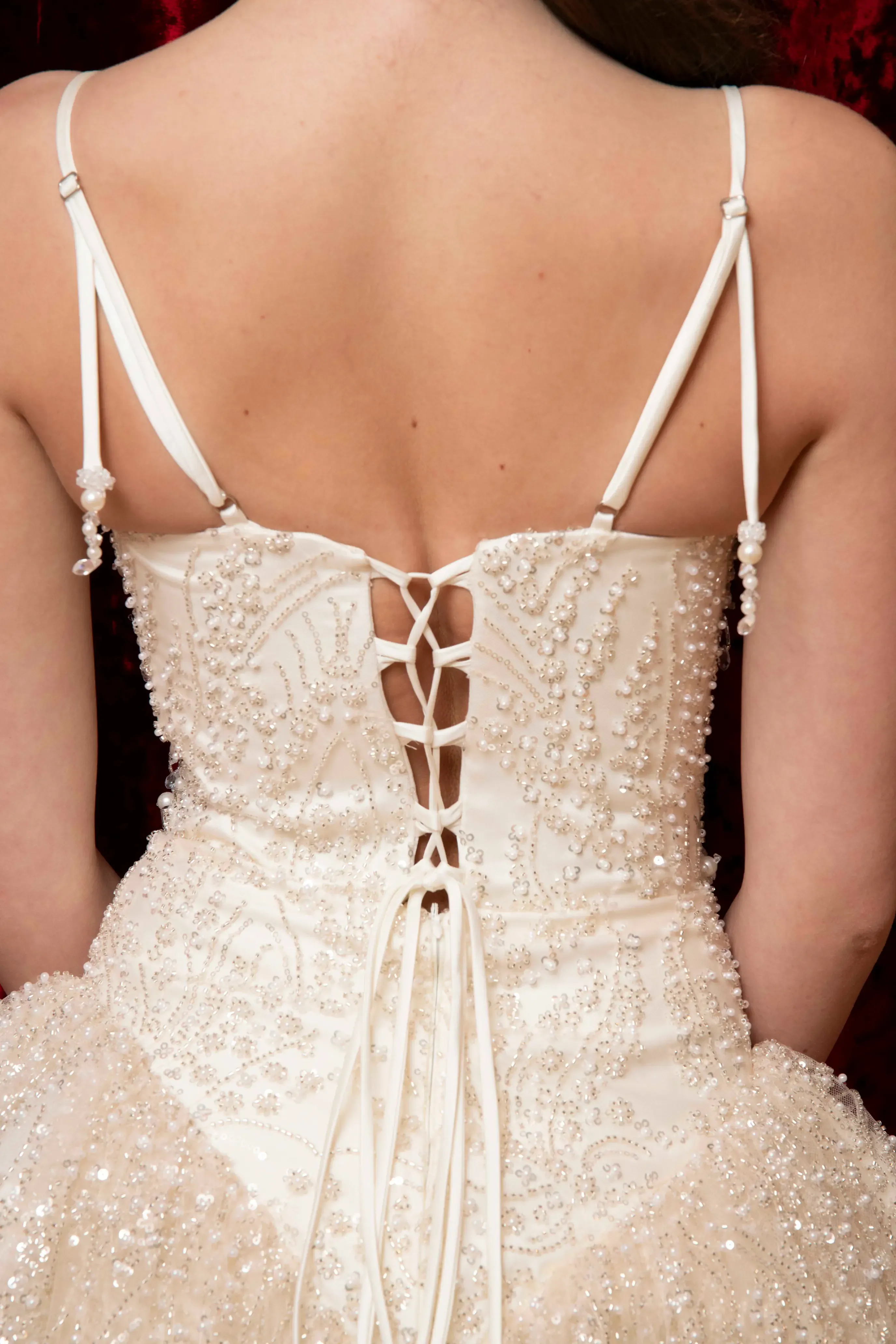 The draped back of a pale blue Sharrini dress